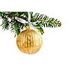 Golden Christmas decoration hanging on pine branch isolated on white