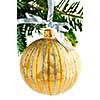 Golden Christmas decoration hanging on pine branch isolated on white