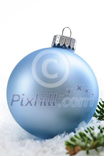 Blue Christmas decoration in snow with pine branches