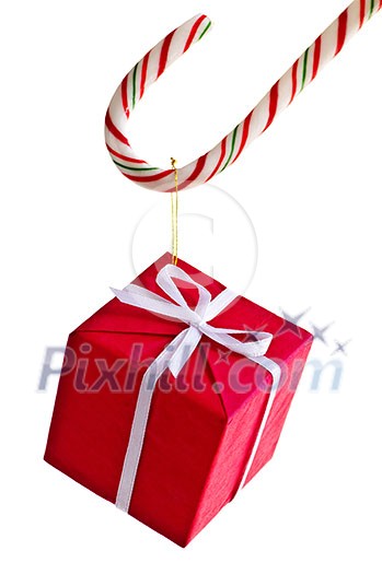 Closeup of striped candy cane with gift box isolated on white