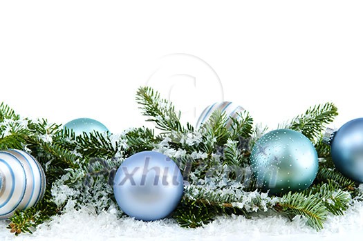 Many Christmas decorations laying in pine branches and snow