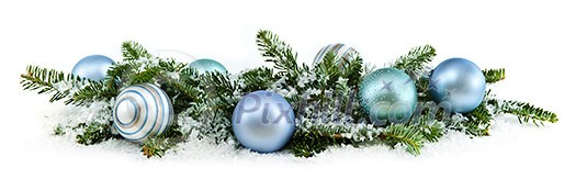 Many Christmas decorations laying in pine branches and snow
