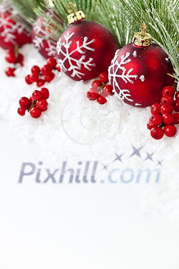 Red Christmas decorations with pine branches with copy space