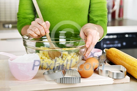 Mixing ingredients for baking cookies in glass bowl