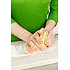 Hands kneading ball of dough with flour on cutting board