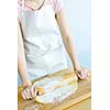 Spreading out cookie dough with wooden rolling pin