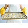 Woman holding a cookie tray with homemade cookies for baking