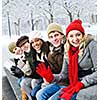 Group of diverse young friends waving hello outdoors in winter