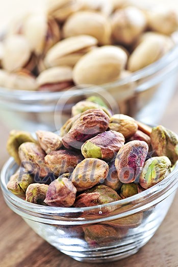 Close up of pistachio nuts in glass bowls