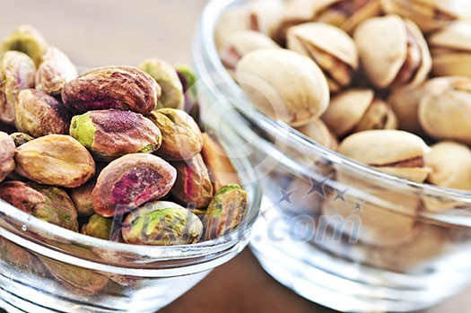 Close up of pistachio nuts in glass bowls