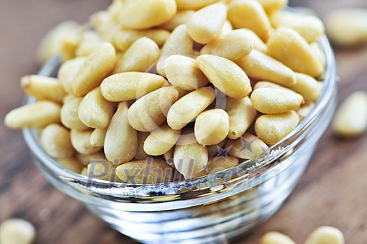 Close up of pine nuts in glass bowl Close up of pine nuts in glass bowl
