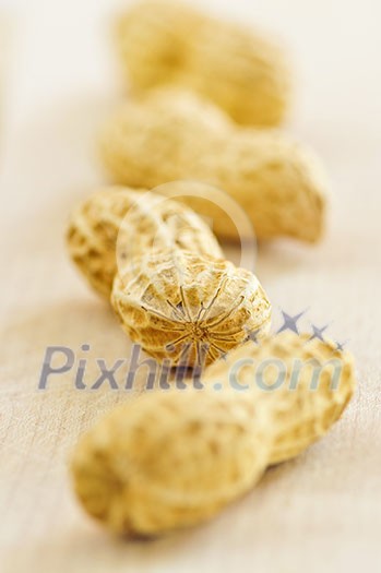 Closeup of peanuts with shells in a row Closeup of peanuts with shells in a row