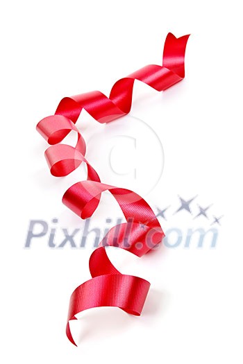 Curled red holiday ribbon strip isolated on white background