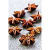 Dry star anise fruit and seeds on wooden background