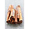 Several cinnamon bark sticks on wooden background