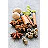 Assorted whole spices close up on wooden background