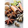 Assorted whole spices close up on wooden background