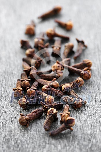 Several dried clove buds on wooden background Several dried clove buds on wooden background