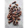 Several dried clove buds on wooden background