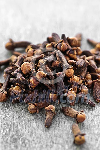 Several dried clove buds on wooden background Several dried clove buds on wooden background