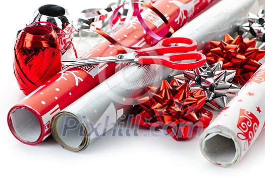 Rolls of Christmas wrapping paper with ribbons, bows and scissors