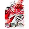 Rolls of Christmas wrapping paper with ribbons, bows and scissors