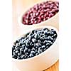 Dry black and red adzuki beans in bowls