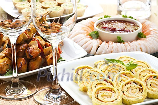 Many dishes of bite size appetizers and party food