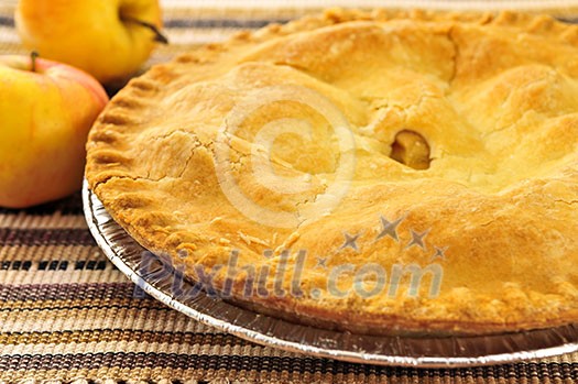 Whole apple pie with apples close up