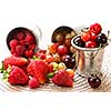 Assorted summer fruits and berries in metal pails