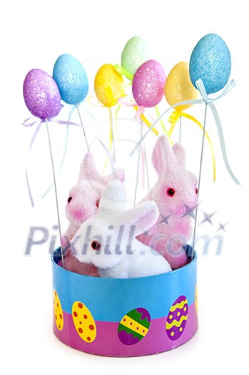 Cute Easter bunny toys in basket with balloons isolated on white background