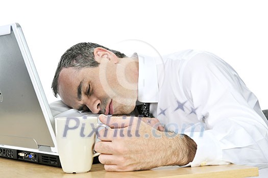 Tired businessman asleep at his desk isolated on white background