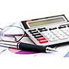 Calculating numbers for income tax return with glasses pen and calculator