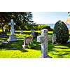 Bright graveyard lawn with ancient tombstone crosses