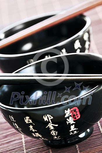 Two rice bowls and chopsticks close up Two rice bowls and chopsticks close up