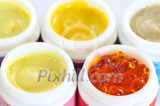 Colorful jars of skin care creams and lotions Colorful jars of skin care creams and lotions