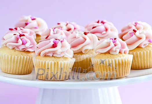 Lots of tasty cupcakes with icing on serving tray Lots of tasty cupcakes with icing on serving tray