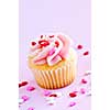 Single cupcake with pink icing and sprinkles