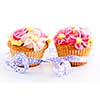Pair of cupcakes with icing flowers and ribbon