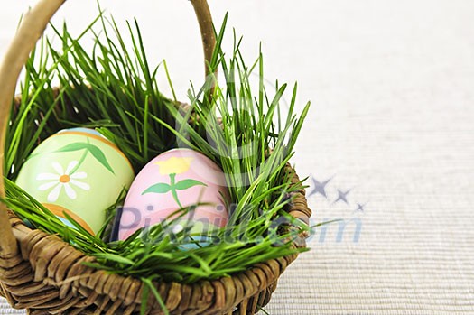Easter eggs arrangement with green grass in a basket