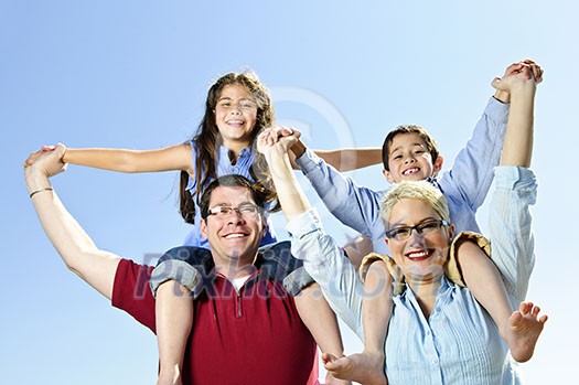 Happy family having fun giving shoulder rides