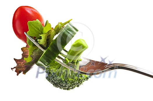 Fresh vegetables on a fork isolated on white background