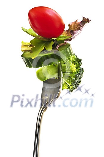 Fresh vegetables on a fork isolated on white background Fresh vegetables on a fork isolated on white background