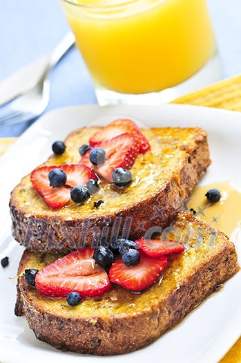 Breakfast of french toast with fresh berries and maple syrup