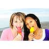Portrait of two teenage girls eating ice cream cones