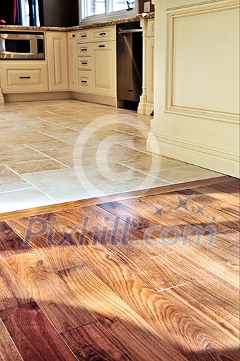 Hardwood and tile floor in residential home kitchen and dining room
