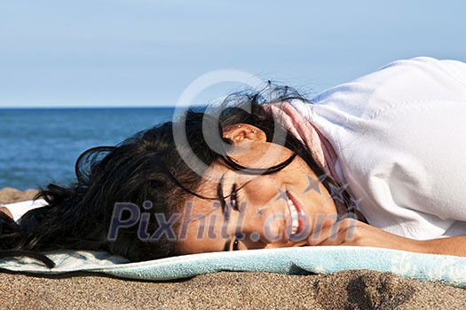 Portrait of beautiful smiling native american girl laying at beach Portrait of beautiful smiling native american girl laying at beach