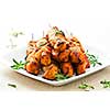 Pile of barbecued chicken kebab appetizers on a plate