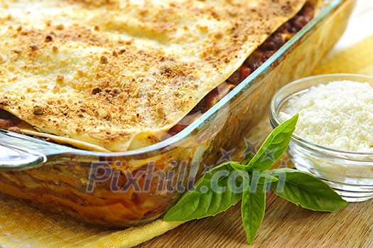 Fresh baked lasagna casserole with grated parmesan cheese Fresh baked lasagna casserole with grated parmesan cheese