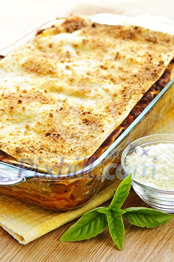 Fresh baked lasagna casserole with grated parmesan cheese Fresh baked lasagna casserole with grated parmesan cheese